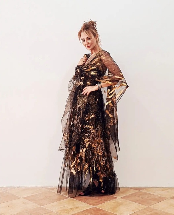 Roula Harb — Black & Gold Sheer Dress, holding collar