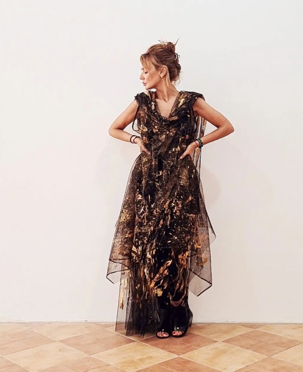 Roula Harb — Black & Gold Sheer Dress, hands on hips